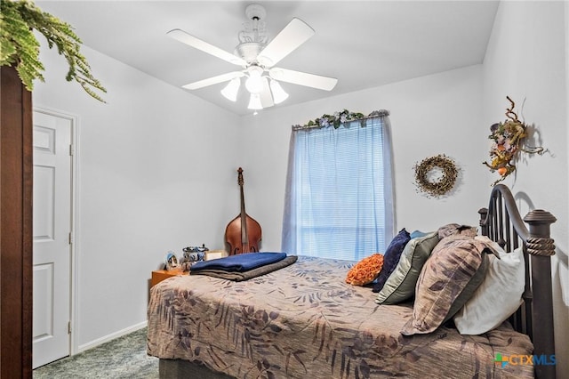 carpeted bedroom with a ceiling fan and baseboards