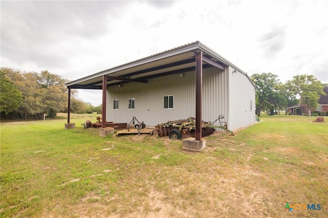 back of house with a lawn