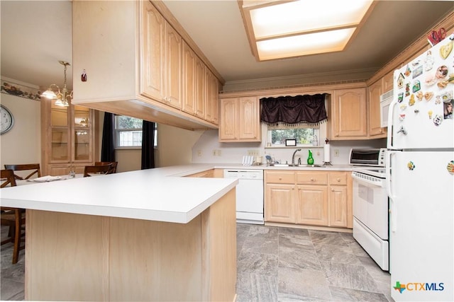 kitchen with a peninsula, white appliances, a kitchen breakfast bar, light countertops, and light brown cabinetry