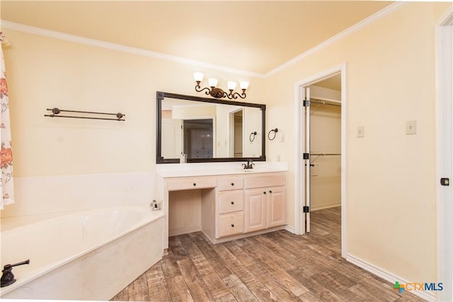 full bath with crown molding, a spacious closet, vanity, wood finished floors, and a bath