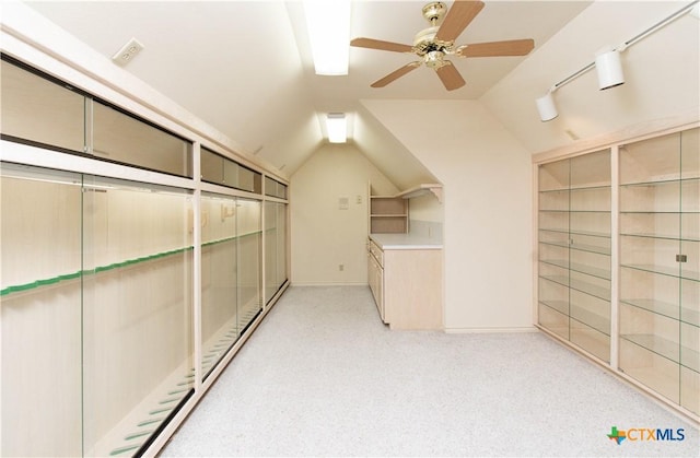 spacious closet with lofted ceiling, ceiling fan, and light carpet