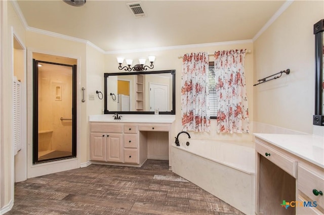 bathroom with a garden tub, wood finished floors, visible vents, vanity, and crown molding