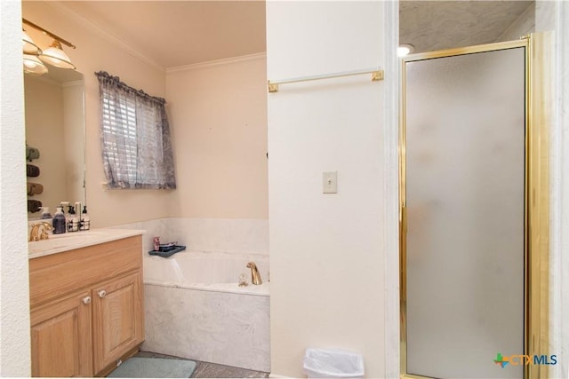 bathroom featuring a garden tub, a shower stall, crown molding, and vanity