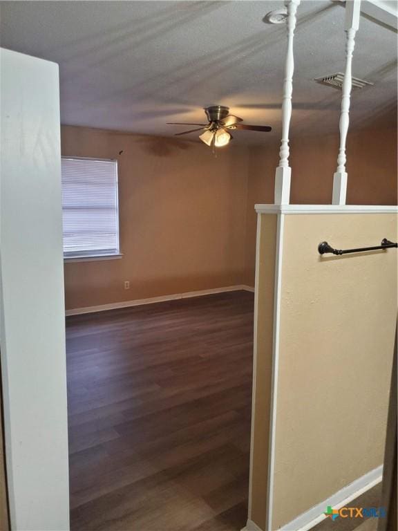 interior space featuring ceiling fan and dark hardwood / wood-style floors