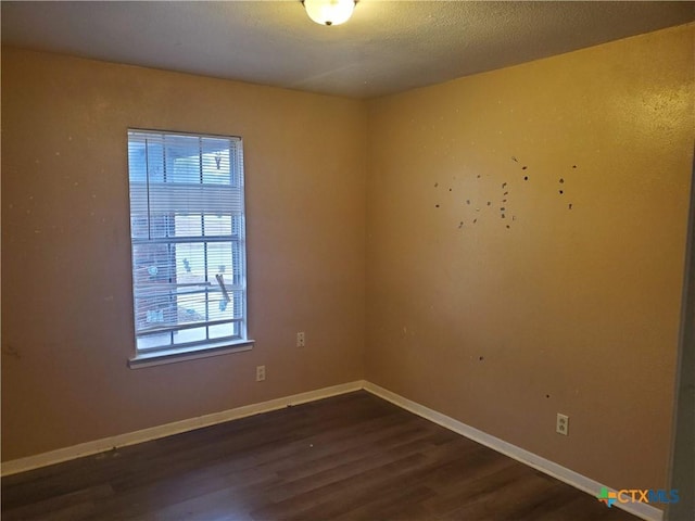 empty room featuring dark wood-type flooring