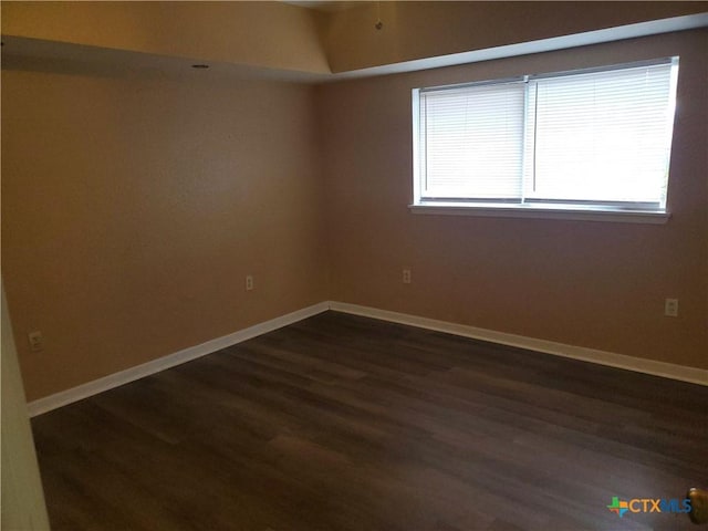 empty room featuring dark wood-type flooring