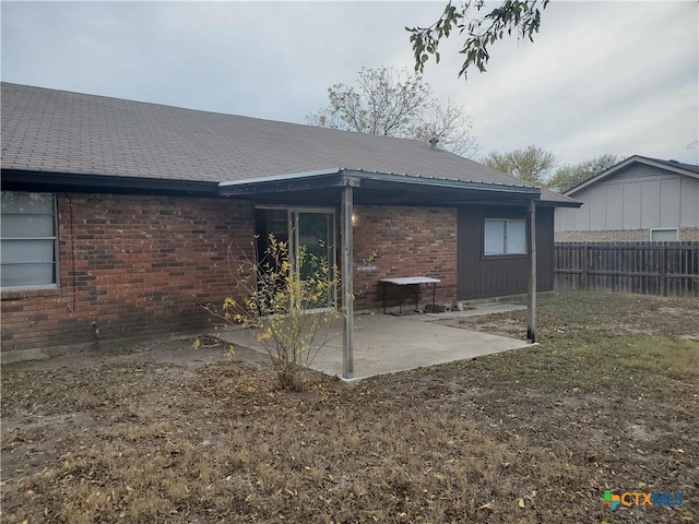 back of house featuring a yard and a patio