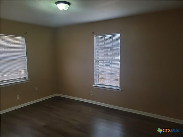 spare room featuring dark hardwood / wood-style flooring