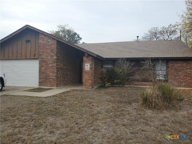 ranch-style home with a front yard and a garage