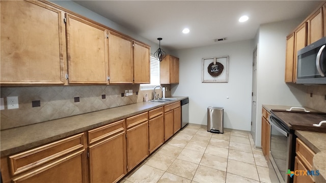 kitchen featuring sink, appliances with stainless steel finishes, tasteful backsplash, light tile patterned floors, and decorative light fixtures