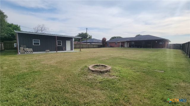 view of yard featuring a fire pit and a patio area