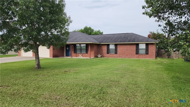 ranch-style house featuring a garage and a front lawn