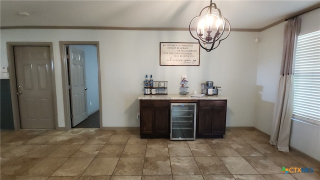 bar with dark brown cabinetry, a notable chandelier, crown molding, pendant lighting, and wine cooler