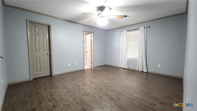 unfurnished room with ceiling fan, dark hardwood / wood-style floors, and ornamental molding