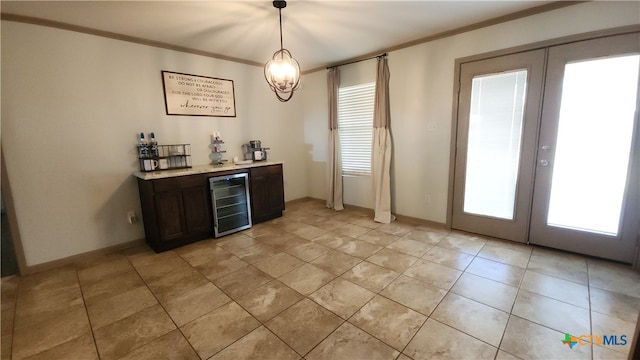 bar featuring wine cooler, hanging light fixtures, french doors, and crown molding