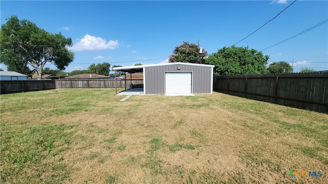 view of yard featuring a garage and an outdoor structure