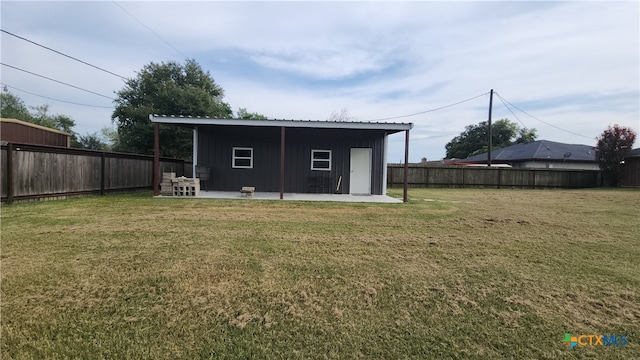 rear view of property featuring a patio and a yard