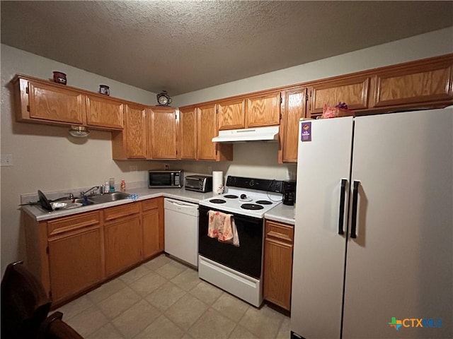 kitchen with sink, white appliances, and a textured ceiling