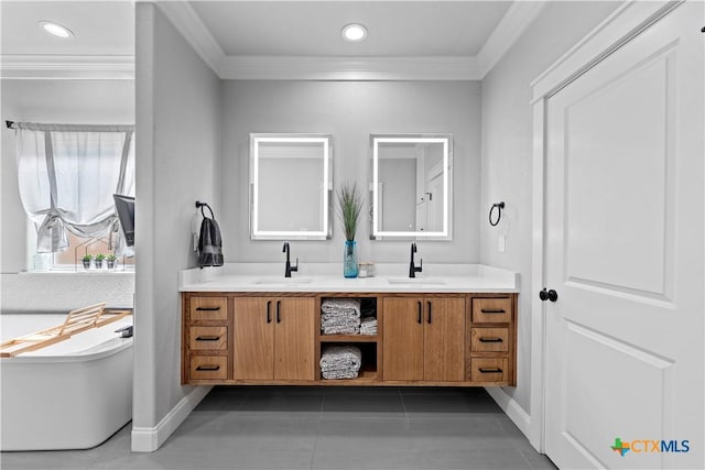 bathroom with a bath, vanity, crown molding, and tile patterned floors