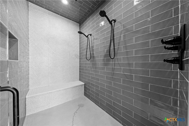 bathroom with a tile shower