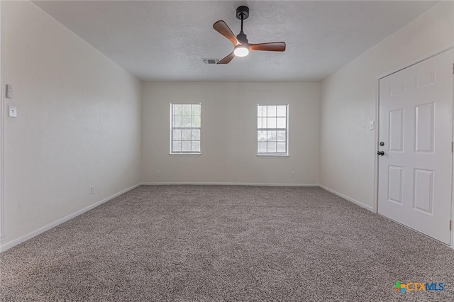 unfurnished room featuring ceiling fan and carpet flooring