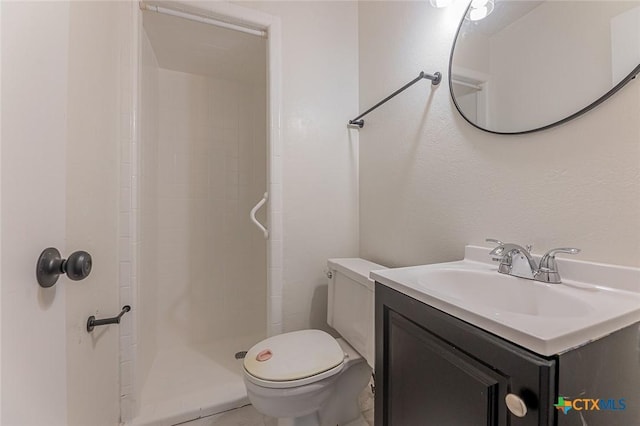 bathroom with vanity, toilet, and a shower