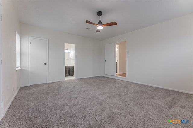 unfurnished bedroom with carpet floors, a closet, ceiling fan, and ensuite bathroom