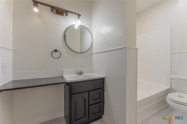 full bathroom with bathtub / shower combination, toilet, tile walls, vanity, and tile patterned flooring