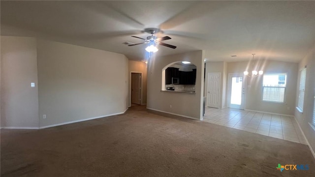 5711 Stonehaven Dr, Temple, TX 76502 - unfurnished living room featuring light carpet, arched walkways, a ceiling fan, a chandelier, and light tile patterned flooring