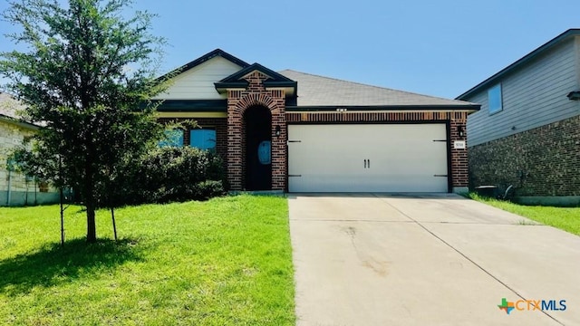 5711 Stonehaven Dr, Temple, TX 76502 - view of front of property featuring a garage, a front yard, brick siding, and concrete driveway