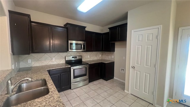 5711 Stonehaven Dr, Temple, TX 76502 - kitchen with stainless steel appliances, decorative backsplash, light tile patterned floors, and light stone counters