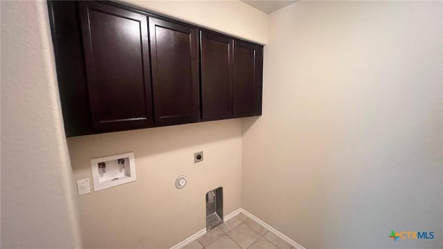 5711 Stonehaven Dr, Temple, TX 76502 - laundry area with electric dryer hookup, cabinet space, washer hookup, light tile patterned flooring, and hookup for a gas dryer
