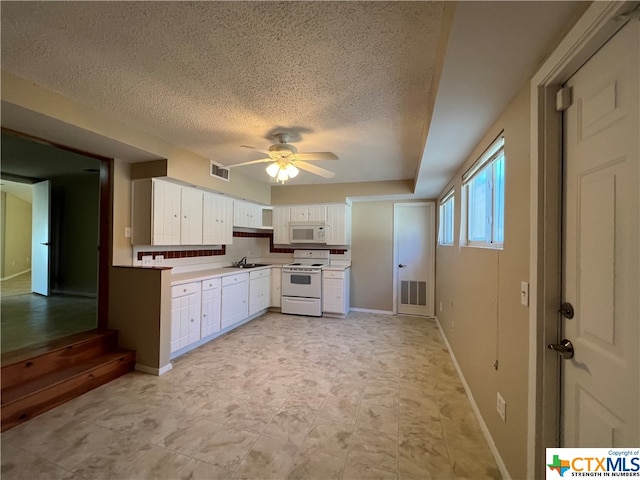 kitchen with a textured ceiling, white appliances, ceiling fan, sink, and white cabinetry