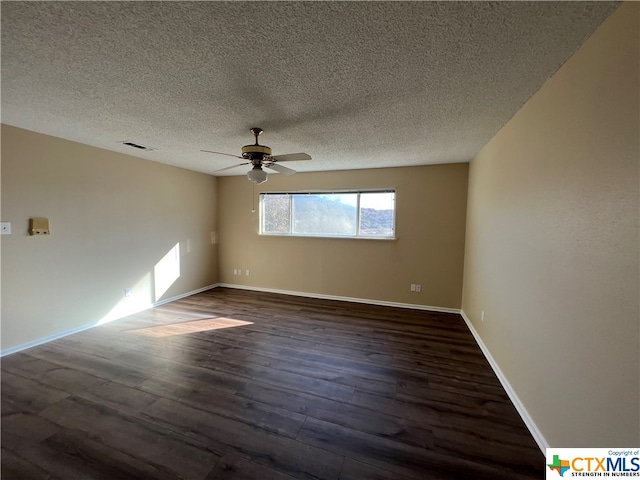 spare room with ceiling fan, dark hardwood / wood-style flooring, and a textured ceiling