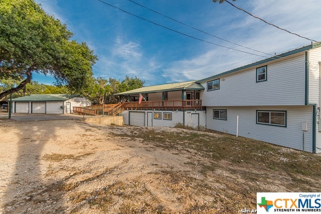 back of property with a wooden deck