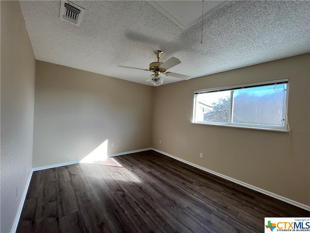 empty room with a textured ceiling, ceiling fan, and dark wood-type flooring