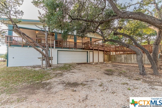 exterior space with a garage and a deck