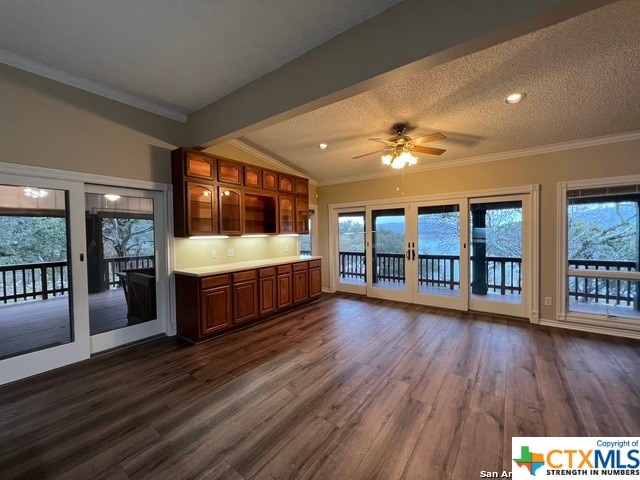 kitchen with lofted ceiling with beams, ceiling fan, a textured ceiling, and dark wood-type flooring