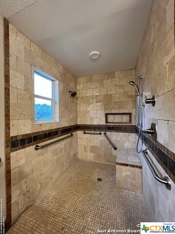 bathroom with a tile shower