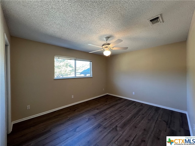 unfurnished room featuring dark hardwood / wood-style floors, ceiling fan, and a textured ceiling