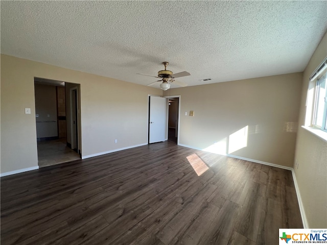 spare room featuring a textured ceiling, ceiling fan, and dark hardwood / wood-style floors