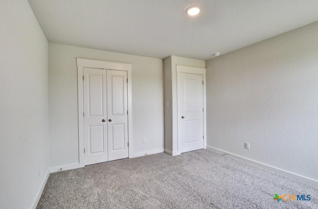3625 Meteor Rd, New Braunfels, TX 78130 - unfurnished bedroom with carpet flooring, baseboards, and a closet