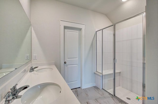 3625 Meteor Rd, New Braunfels, TX 78130 - full bathroom featuring a shower stall, double vanity, marble look tiles, and vaulted ceiling