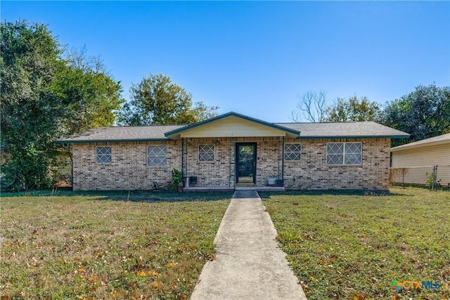 single story home featuring a front lawn and brick siding