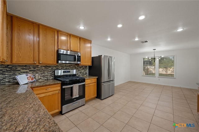 16503 Lounsbury Pl, Austin, TX 78717 - kitchen with appliances with stainless steel finishes, backsplash, brown cabinets, light tile patterned floors, and recessed lighting