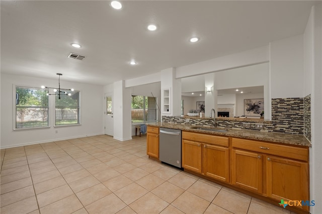 16503 Lounsbury Pl, Austin, TX 78717 - kitchen featuring dishwasher, decorative backsplash, dark stone counters, a chandelier, and brown cabinetry