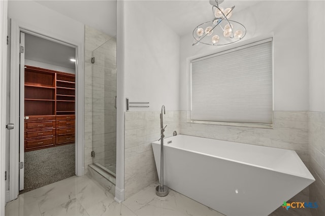 16503 Lounsbury Pl, Austin, TX 78717 - full bathroom with a freestanding tub, tile walls, a chandelier, marble finish flooring, and a shower stall