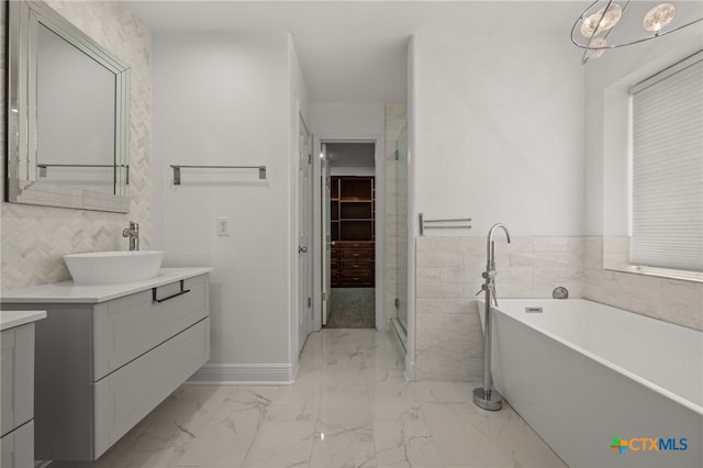 16503 Lounsbury Pl, Austin, TX 78717 - bathroom with vanity, a freestanding bath, marble finish floors, a stall shower, and tile walls