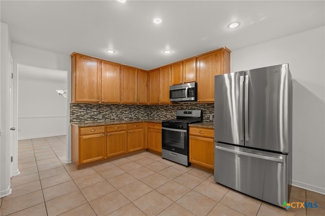 16503 Lounsbury Pl, Austin, TX 78717 - kitchen with backsplash, stainless steel appliances, baseboards, and light tile patterned flooring