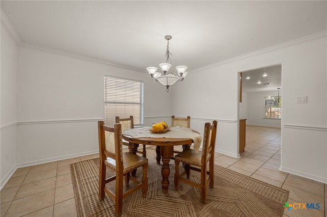 16503 Lounsbury Pl, Austin, TX 78717 - dining room featuring light tile patterned floors, crown molding, and a chandelier